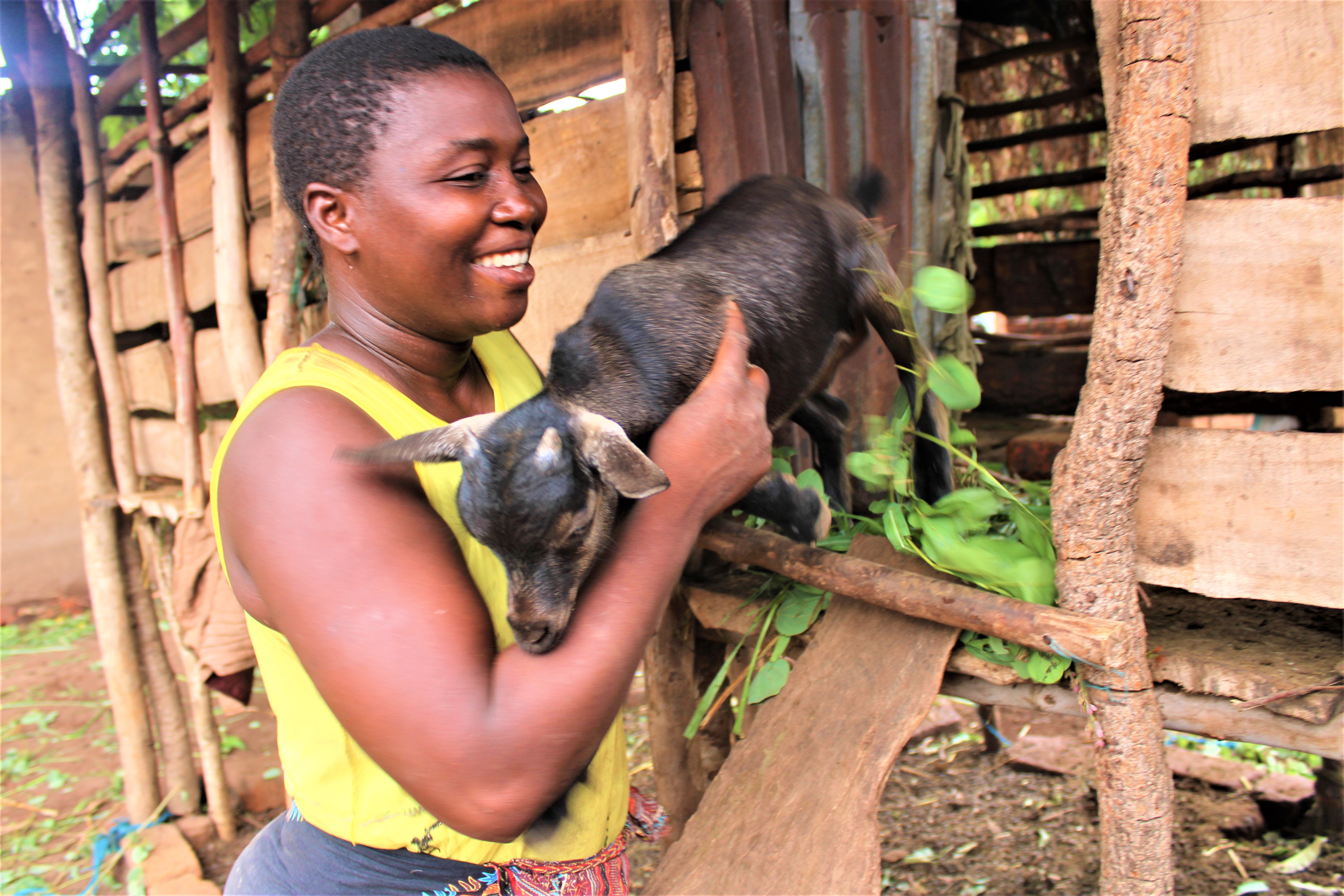 Matilda Kuntaja helping a young goat out of the kraal. This goat will be passed on to another beneficiary in August 2022. Credit: Felix Malamula (PRIDE)